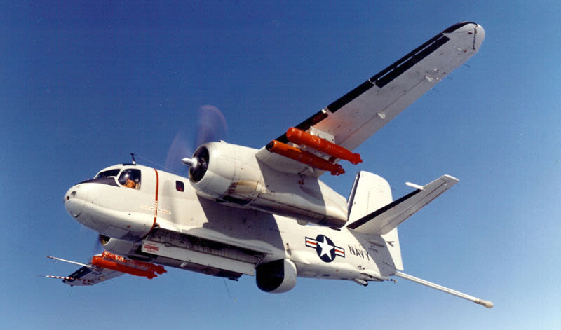 An S-2 Tracker armed with torpedoes and with its MAD boom extended (US Navy)